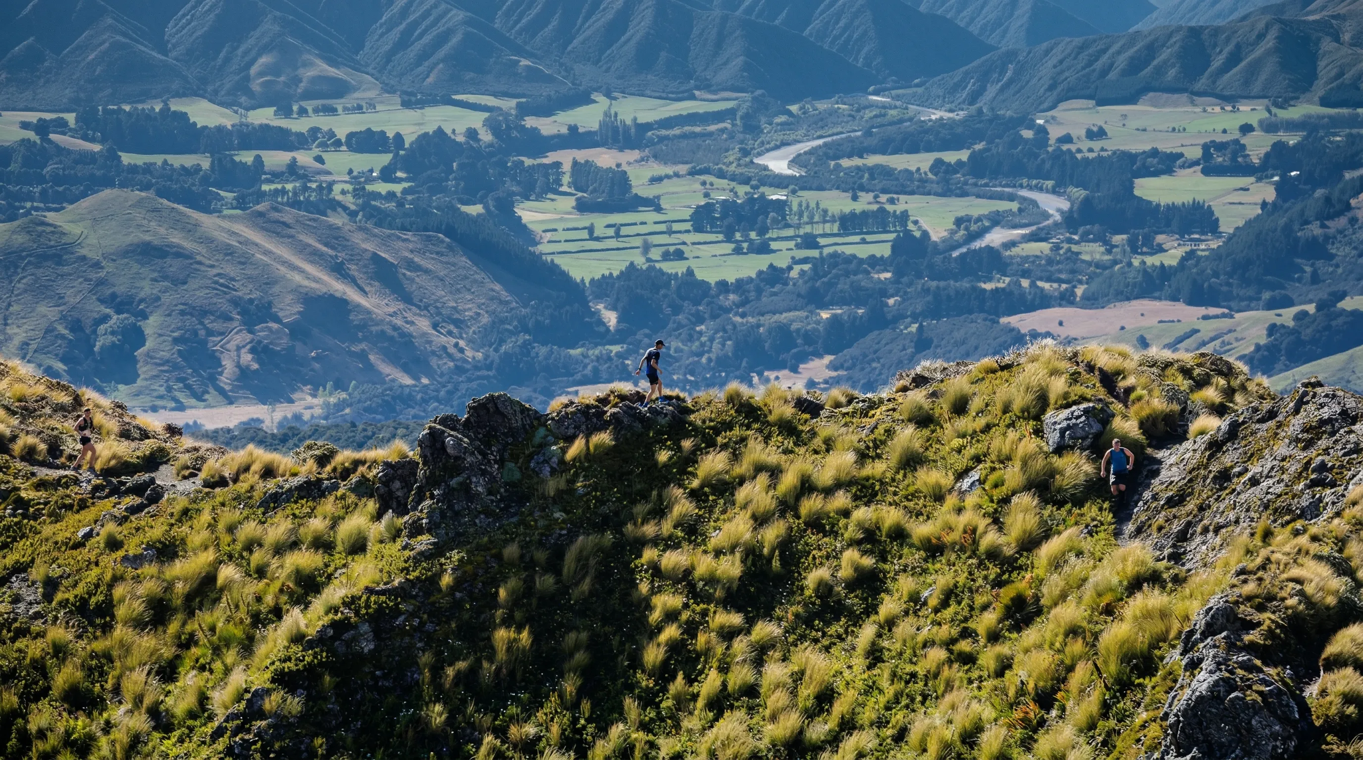 A lone runner on a rocky crag high above the Wairarapa plains